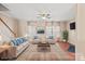 Spacious living room with staircase, hardwood floors and comfortable seating at 9724 Walkers Glen Nw Dr, Concord, NC 28027
