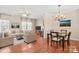 Open-concept living room and dining area with hardwood floors at 9724 Walkers Glen Nw Dr, Concord, NC 28027