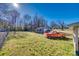 Property showcasing a lush backyard with mature trees, a detached garage, and a classic orange truck at 102 Fire Department Dr, Belmont, NC 28012