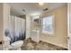 Functional bathroom with a toilet, vanity, medicine cabinet, shower with curtain, and window for natural light at 102 Fire Department Dr, Belmont, NC 28012