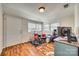 Versatile room with laminate floors, ideal for a music room, featuring a full drum set, desk, and natural light at 102 Fire Department Dr, Belmont, NC 28012
