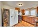 Traditional kitchen featuring wood cabinets, modern appliances, and plenty of natural light, with wood-look flooring at 102 Fire Department Dr, Belmont, NC 28012