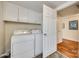 Convenient laundry room with a washer, dryer, overhead cabinets, and easy access to the home's interior at 102 Fire Department Dr, Belmont, NC 28012