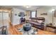 Cozy living room with a comfortable leather sofa, unique coffee table, and stylish decor on wood-look flooring at 102 Fire Department Dr, Belmont, NC 28012