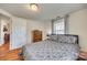 Comfortable main bedroom featuring wood-look flooring, a dresser, a plush bed with patterned bedding, and natural light at 102 Fire Department Dr, Belmont, NC 28012