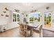 Dining area with large windows, modern lighting, and stylish decor. Butterfly themed decorations add charm at 1029 Dali Blvd, Mount Holly, NC 28120