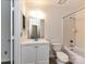 Bright bathroom with vanity, mirror, toilet, and tiled bathtub/shower combo at 11020 Carmel Crossing Rd, Charlotte, NC 28226