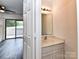 Bathroom with modern sink, cabinet, and mirror is situated near the living area with sliding doors at 11020 Carmel Crossing Rd, Charlotte, NC 28226
