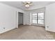 Bedroom with neutral walls, a ceiling fan, walk in closet and a window with natural light at 11020 Carmel Crossing Rd, Charlotte, NC 28226