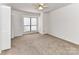 Bedroom with neutral walls, a ceiling fan, and a window with natural light at 11020 Carmel Crossing Rd, Charlotte, NC 28226