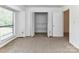 Carpeted bedroom with bright light, closet and doorway at 11020 Carmel Crossing Rd, Charlotte, NC 28226