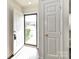 Light filled entryway with an open door, showcasing the outdoor scenery at 11020 Carmel Crossing Rd, Charlotte, NC 28226