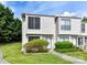 Inviting townhouse with manicured lawn and shrubbery leading to the front door at 11020 Carmel Crossing Rd, Charlotte, NC 28226