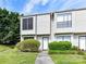 Inviting townhouse with manicured lawn and shrubbery leading to the front door at 11020 Carmel Crossing Rd, Charlotte, NC 28226