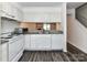 Well lit kitchen with white appliances, granite countertops and wood floors at 11020 Carmel Crossing Rd, Charlotte, NC 28226