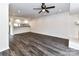 Open-concept living room with modern flooring, ceiling fan, kitchen pass-through and brick fireplace at 11020 Carmel Crossing Rd, Charlotte, NC 28226