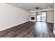 Bright living room featuring sleek floors, brick fireplace and sliding doors to the outside at 11020 Carmel Crossing Rd, Charlotte, NC 28226