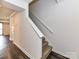 Stairway features carpeted steps and leads to a living area with modern flooring at 11020 Carmel Crossing Rd, Charlotte, NC 28226