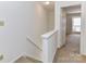 Carpeted stairs lead to an upper level with neutral walls and views to the Primary bedroom at 11020 Carmel Crossing Rd, Charlotte, NC 28226