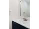 Well-lit half bath featuring a black vanity and white countertop, along with modern fixtures at 130 Valley Glen Dr, Troutman, NC 28166