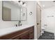 Modern bathroom featuring a wooden vanity, sleek fixtures, and a large mirror with stylish lighting at 130 Valley Glen Dr, Troutman, NC 28166