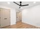 A clean bedroom featuring hardwood floors, ceiling fan, and closet space at 130 Valley Glen Dr, Troutman, NC 28166