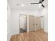 Bright bedroom with hardwood floors and three doors, including access to a bathroom and closet at 130 Valley Glen Dr, Troutman, NC 28166