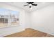 A well-lit bedroom featuring hardwood floors and a large window with a view at 130 Valley Glen Dr, Troutman, NC 28166