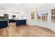 Modern kitchen featuring an island with a navy blue base, stainless steel appliances, and hardwood flooring at 130 Valley Glen Dr, Troutman, NC 28166