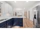 Modern kitchen featuring white cabinets, quartz countertops, stainless steel appliances, and an island with bar seating at 130 Valley Glen Dr, Troutman, NC 28166