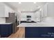 Bright and airy kitchen featuring white cabinets, quartz countertops, stainless steel appliances, and a breakfast bar at 130 Valley Glen Dr, Troutman, NC 28166