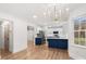 Modern kitchen featuring an island with a navy blue base, stainless steel appliances, and hardwood flooring at 130 Valley Glen Dr, Troutman, NC 28166
