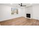 Inviting living room with a modern fireplace, hardwood floors, recessed lighting and a large window at 130 Valley Glen Dr, Troutman, NC 28166