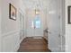 Elegant foyer showcasing hardwood floors, wainscoting, and a stylish light fixture at 14007 Cameryn Elise Dr, Cornelius, NC 28031