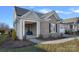 Charming brick home featuring a covered front porch with cozy seating, perfect for relaxing evenings at 14007 Cameryn Elise Dr, Cornelius, NC 28031