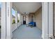 Spacious covered front porch with seating, perfect for enjoying outdoor living and neighborhood views at 14007 Cameryn Elise Dr, Cornelius, NC 28031