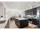 Open kitchen and dining area filled with stainless steel appliances, granite countertops, and pendant lighting at 14007 Cameryn Elise Dr, Cornelius, NC 28031