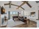 Cozy living room with fireplace, exposed beams, and seamless transition to kitchen area at 14007 Cameryn Elise Dr, Cornelius, NC 28031