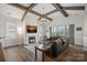 Spacious living room with a fireplace, exposed beams, and comfortable seating at 14007 Cameryn Elise Dr, Cornelius, NC 28031