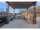 Outdoor kitchen area with stone finishes, grill, and counter space at 14007 Cameryn Elise Dr, Cornelius, NC 28031