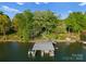 Aerial view of a private boat dock and lift with lush green trees at 141 Baywatch Dr, Mooresville, NC 28117