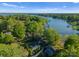 Aerial view of a lakefront neighborhood with lush trees and beautiful landscaping at 141 Baywatch Dr, Mooresville, NC 28117