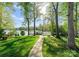Lush backyard leading to a private boat dock on the serene lake at 141 Baywatch Dr, Mooresville, NC 28117