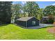 Landscaped backyard with green grass, trees, and beautiful lake views at 141 Baywatch Dr, Mooresville, NC 28117