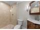 Bathroom featuring a glass shower, vanity, sink, and toilet at 141 Baywatch Dr, Mooresville, NC 28117