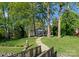 Beautiful home exterior with a winding walkway to the lake and screened in porch with a deck at 141 Baywatch Dr, Mooresville, NC 28117