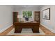 A home office featuring a wooden desk, cabinets, and hardwood floors at 141 Baywatch Dr, Mooresville, NC 28117