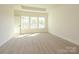 Bright, spacious bedroom with neutral carpeting and large windows that offer ample natural light at 17021 Malone Ln, Mint Hill, NC 28227