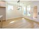 Dining area with three windows, a modern light fixture, and light wood flooring at 17021 Malone Ln, Mint Hill, NC 28227