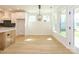 Dining area with access to the kitchen, a modern light fixture, and light wood flooring at 17021 Malone Ln, Mint Hill, NC 28227